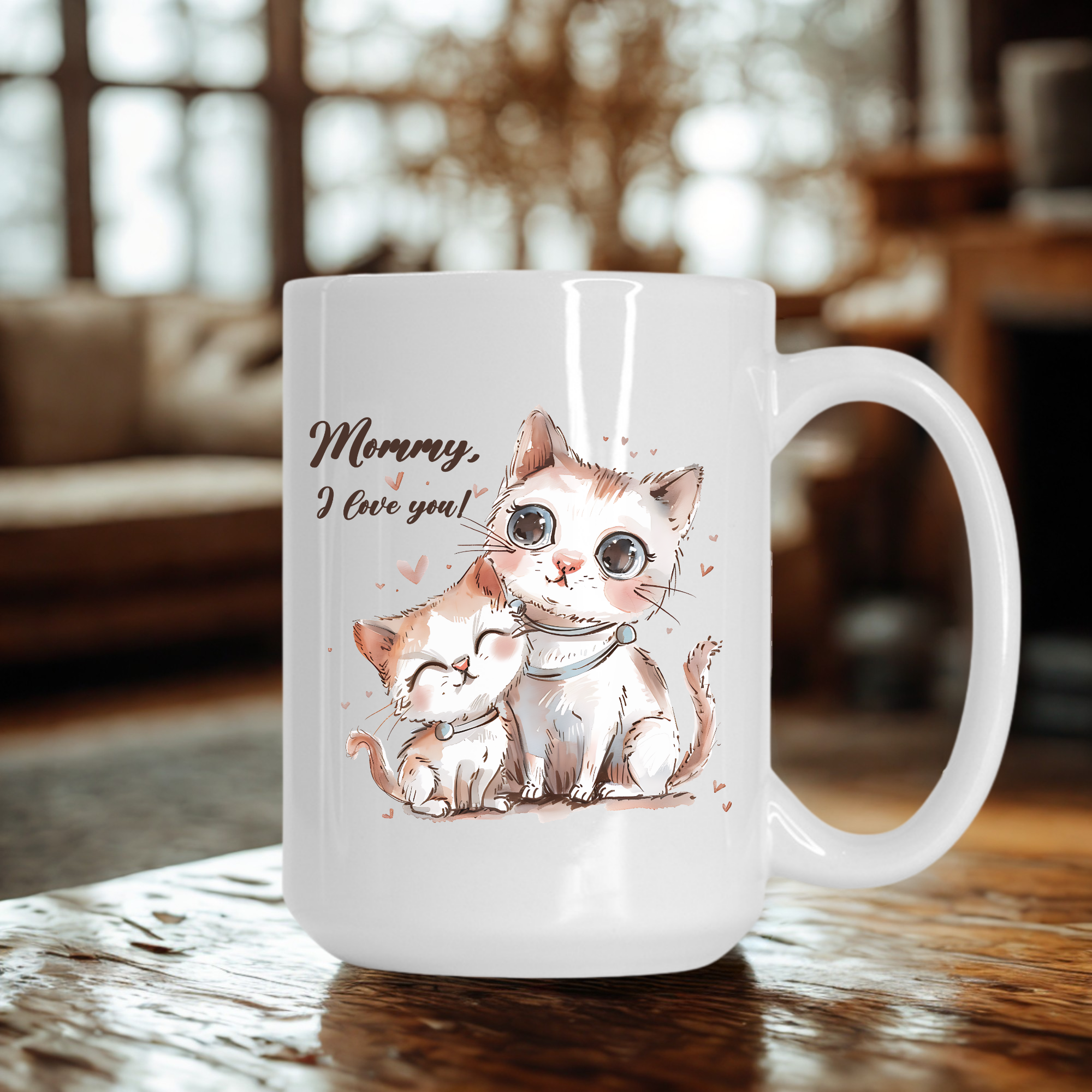 White mug with cat illustration and 'Mommy, I love you!' text on a wooden table.
