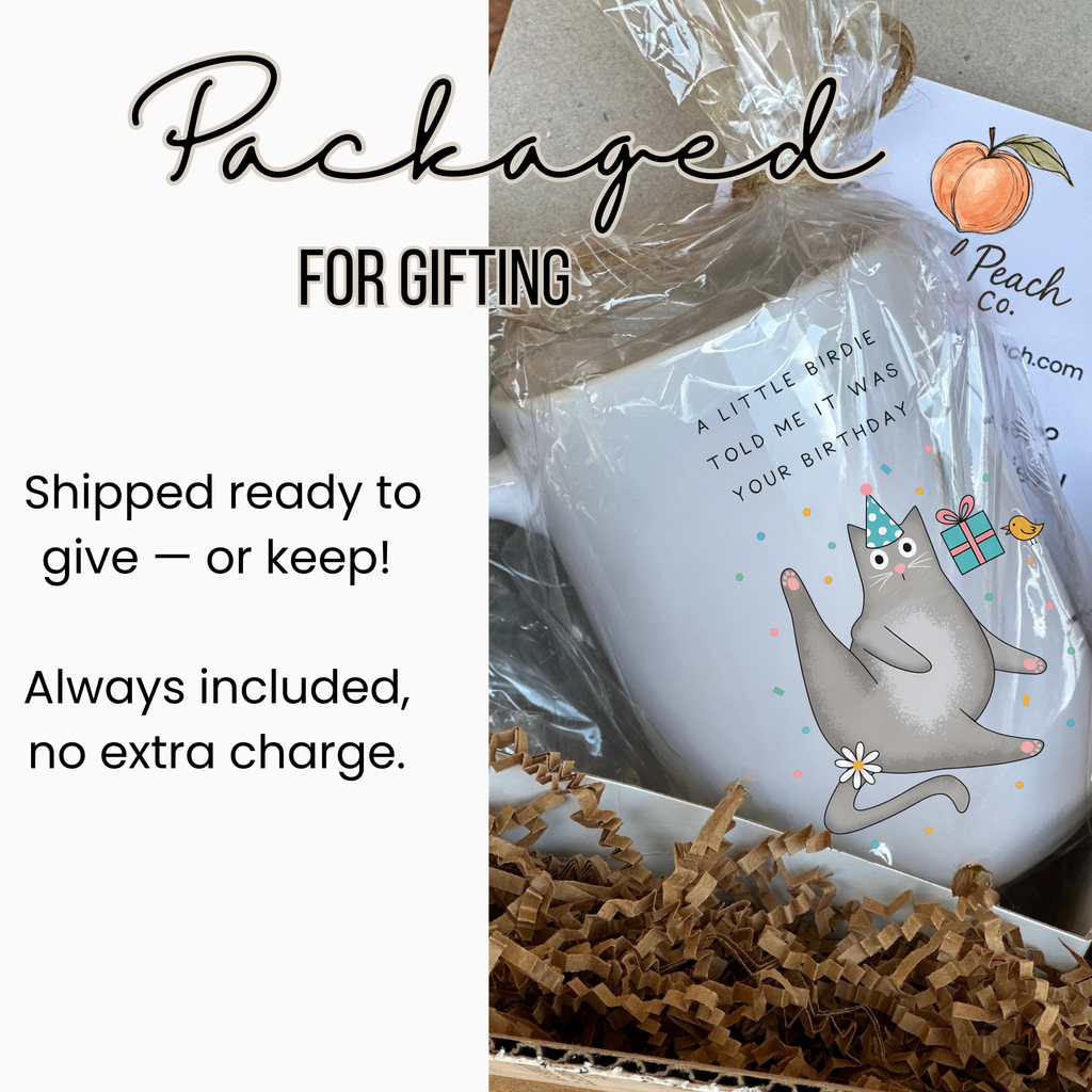 Gift-wrapped mug with a cute illustration of a cat and text about gifting.