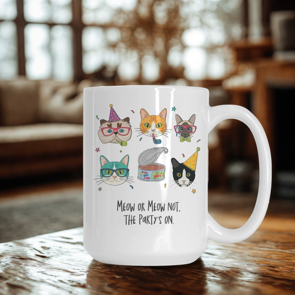 White mug with cat illustrations and text on a wooden table.
