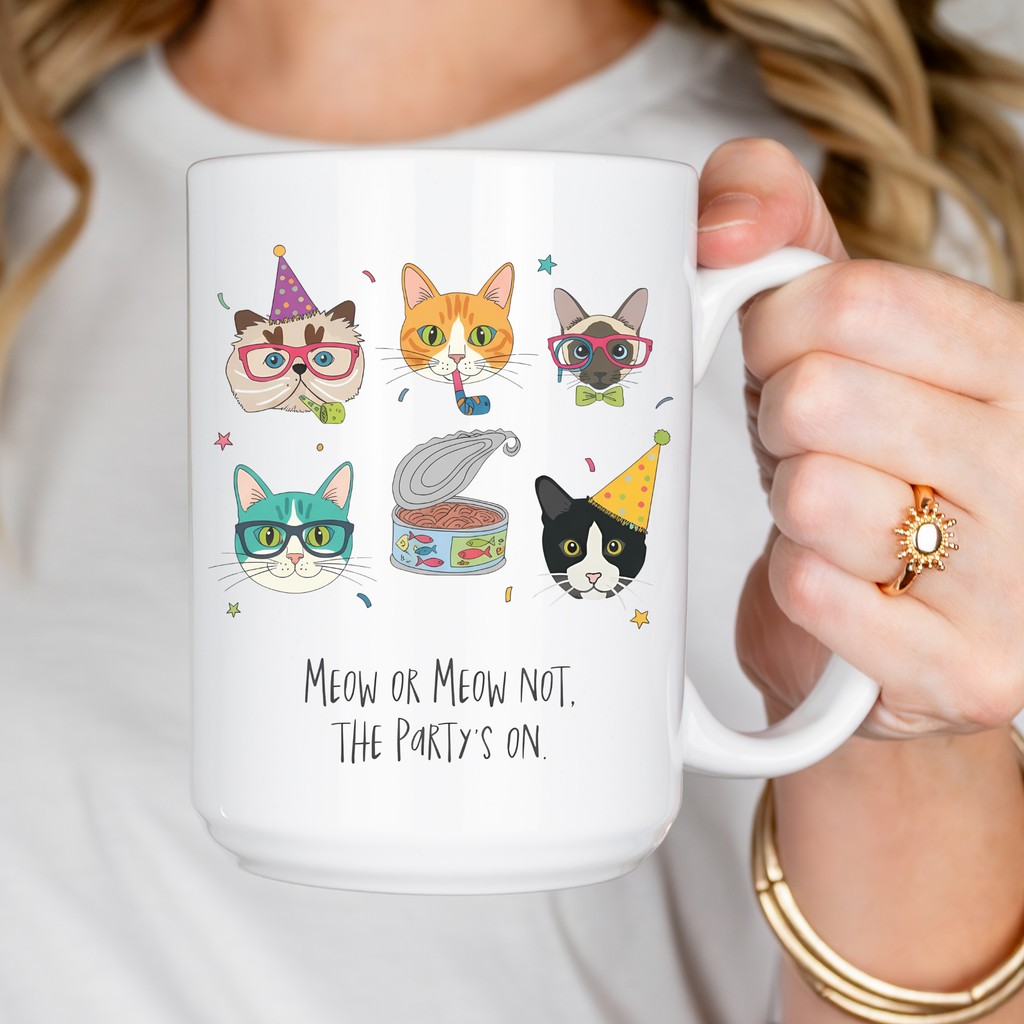 Person holding a mug with cat illustrations and text 'Meow or Meow not, The Party's on.'