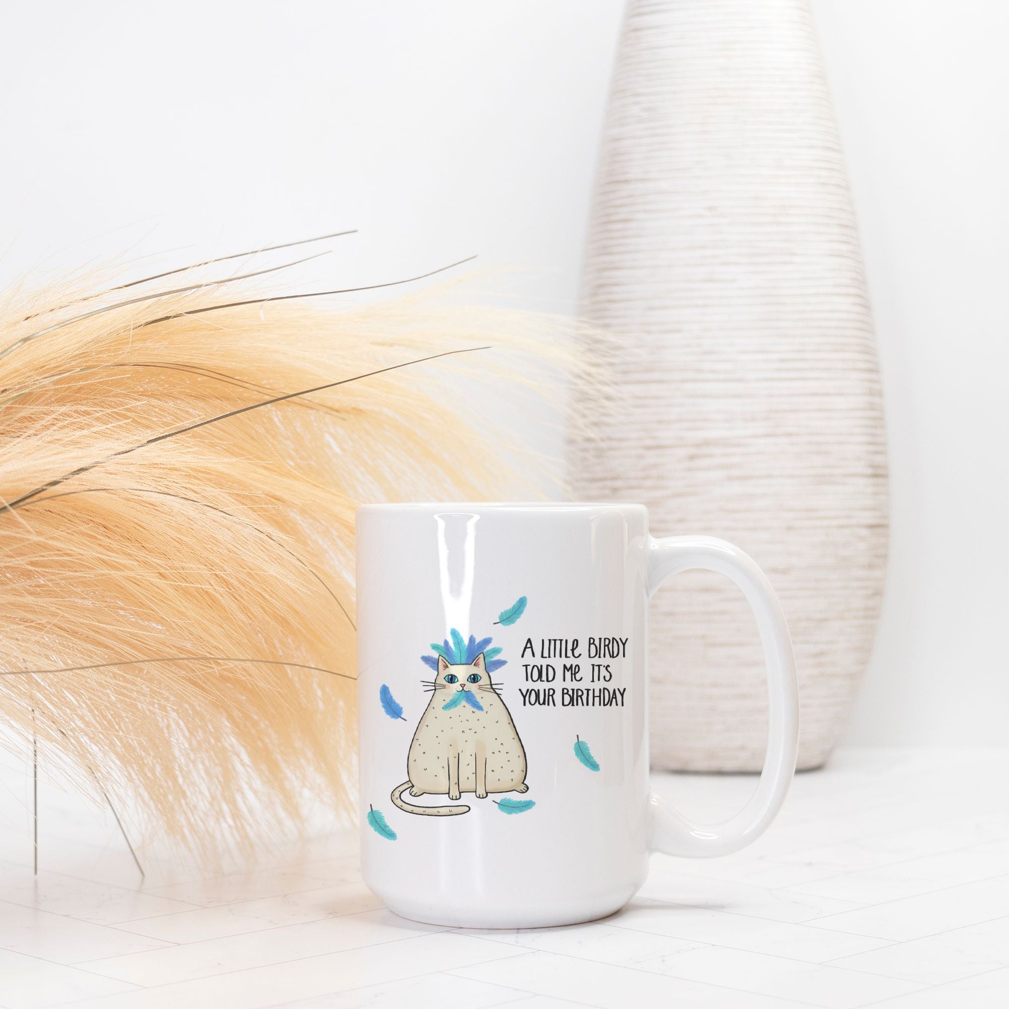White mug with a cat illustration and text on a white background