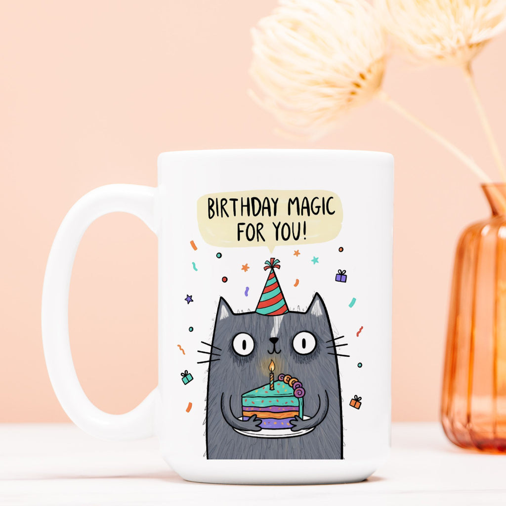 White mug with a cat illustration and 'Birthday Magic For You!' text on a peach background