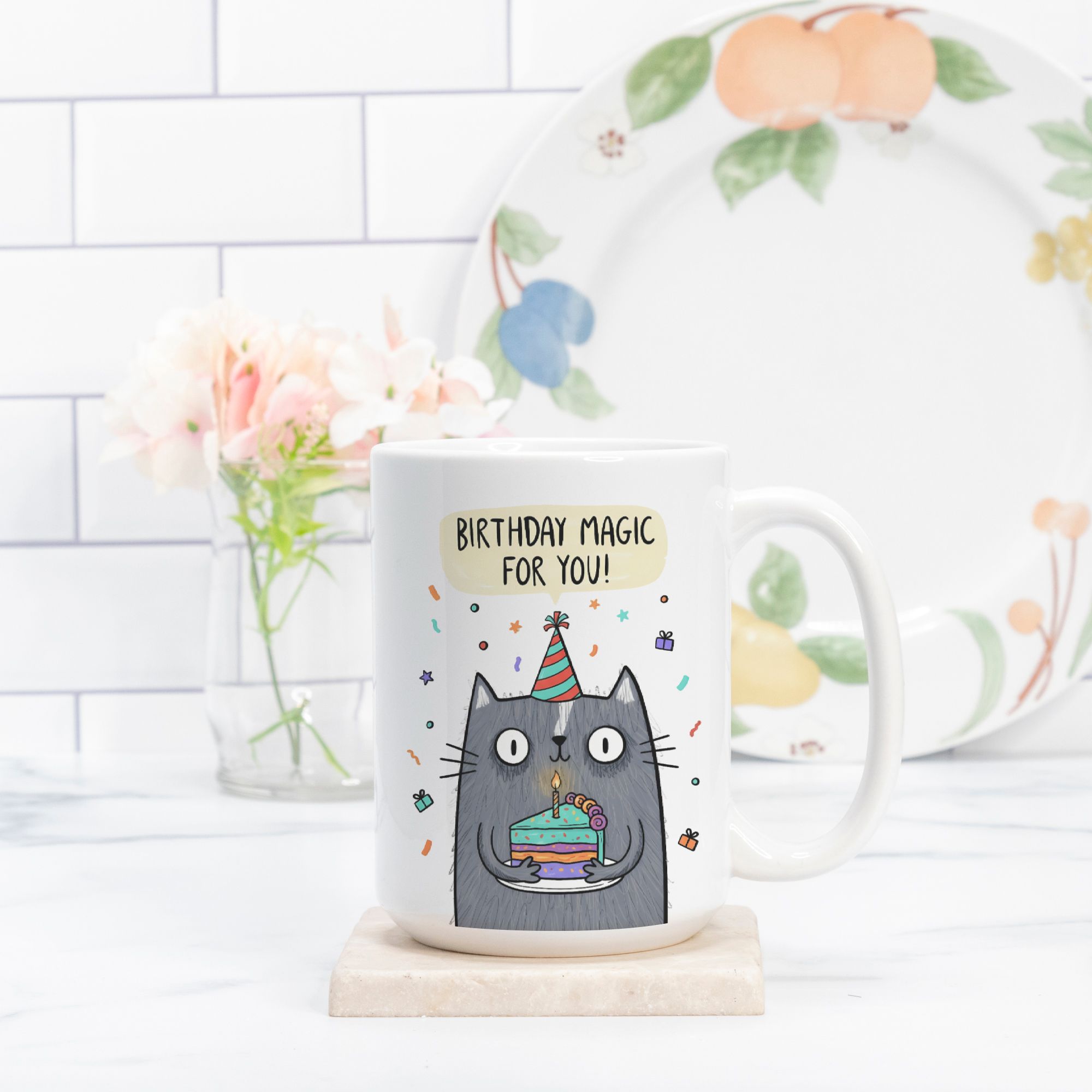 Mug with a cat design and 'Birthday Magic For You!' text on a white surface.