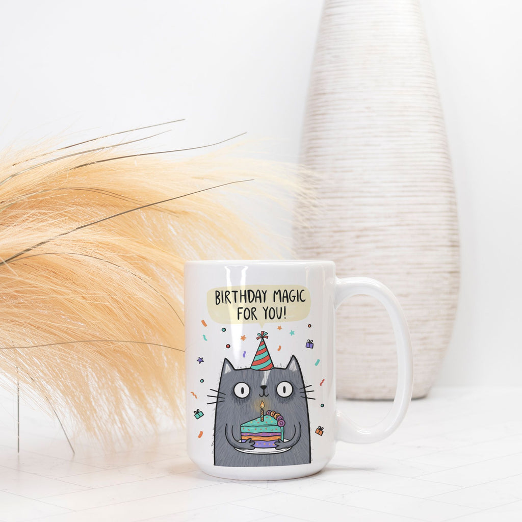 White mug with a cat illustration and 'Birthday Magic For You!' text on a white background