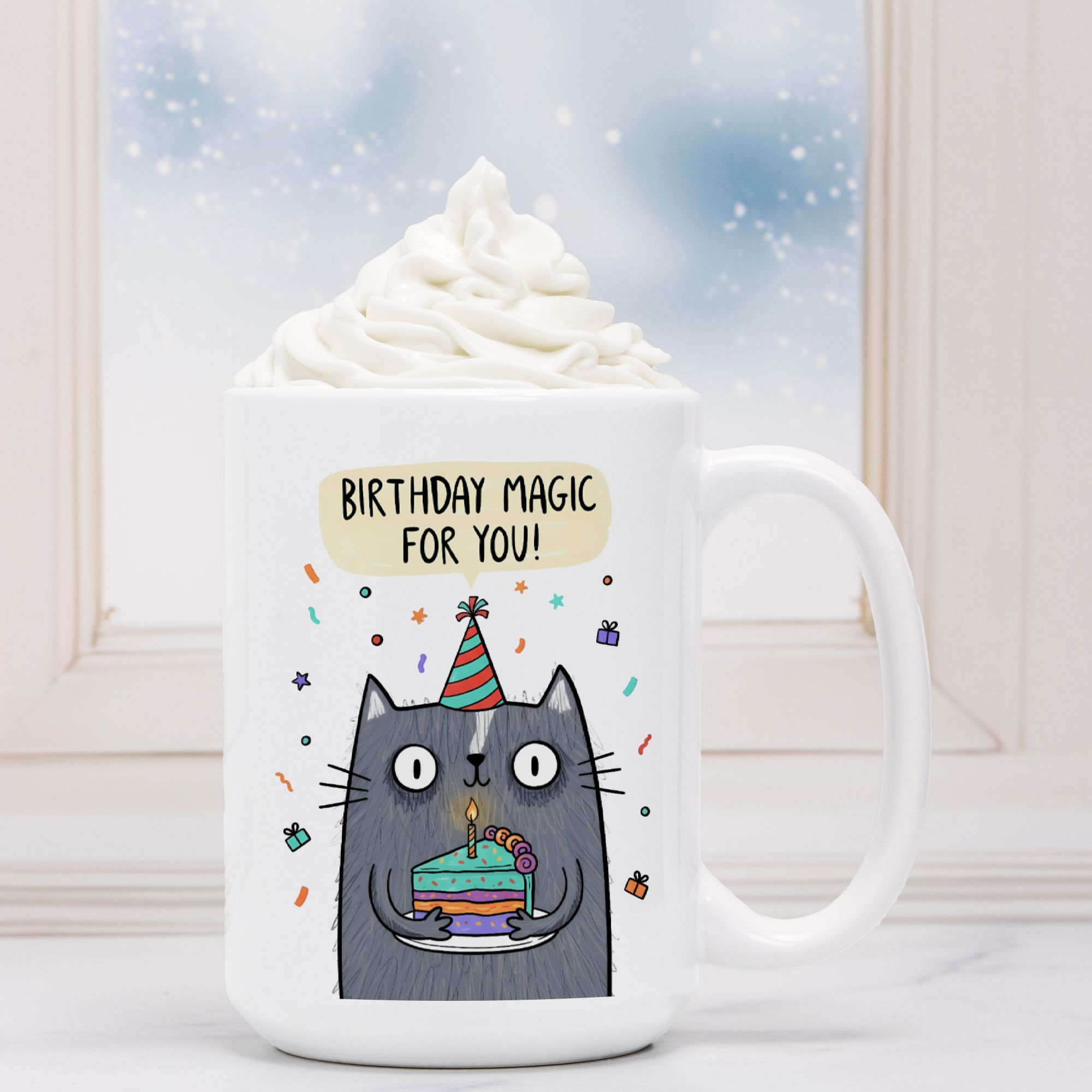 White mug with a cat illustration and 'Birthday Magic For You!' text, filled with whipped cream.