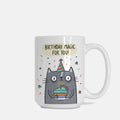 Mug with a cartoon cat holding a birthday cake and the text 'Birthday magic for you!' on a white background.