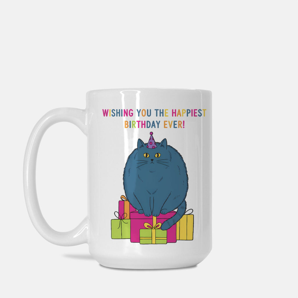 White mug with a blue cat wearing a birthday hat and surrounded by presents, on a white background.