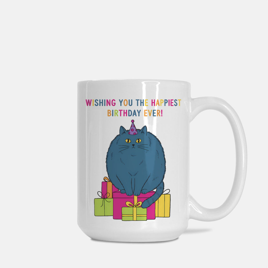 White mug with a blue cat in a birthday hat and presents, and text 'Wishing you the happiest birthday ever!' on a white background.