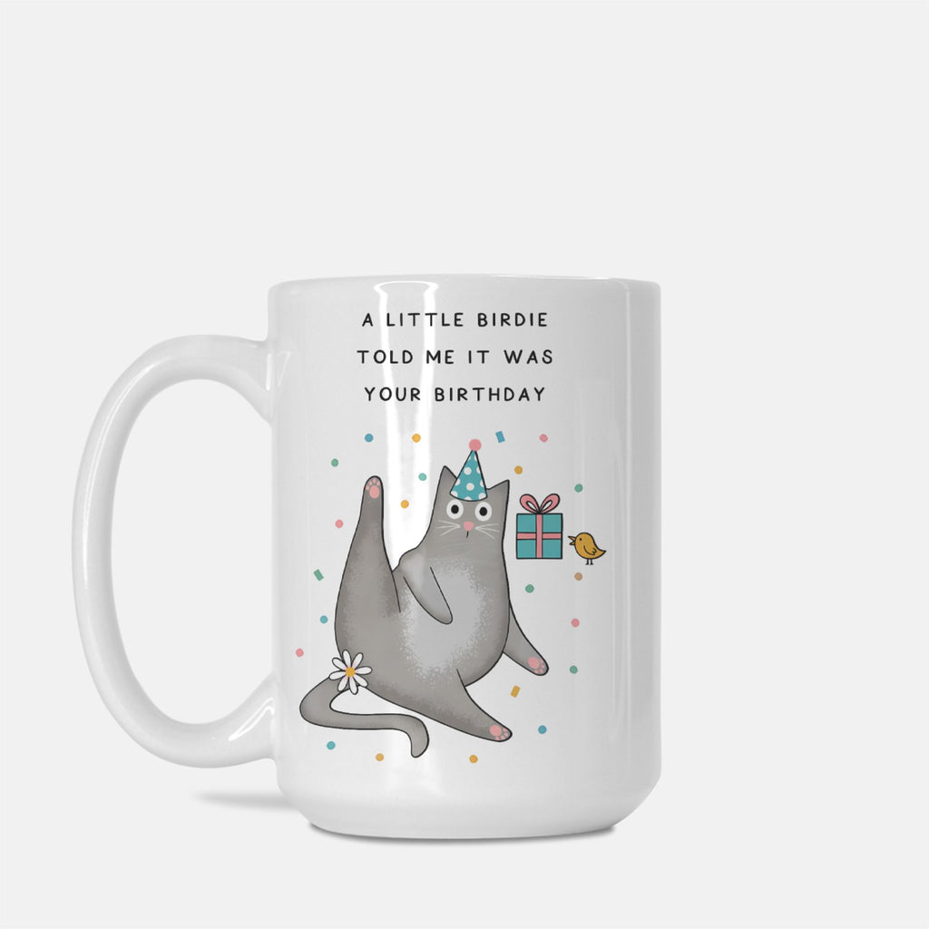 Mug with a cat wearing a party hat and text 'A little birdie told me it was your birthday' on a white background