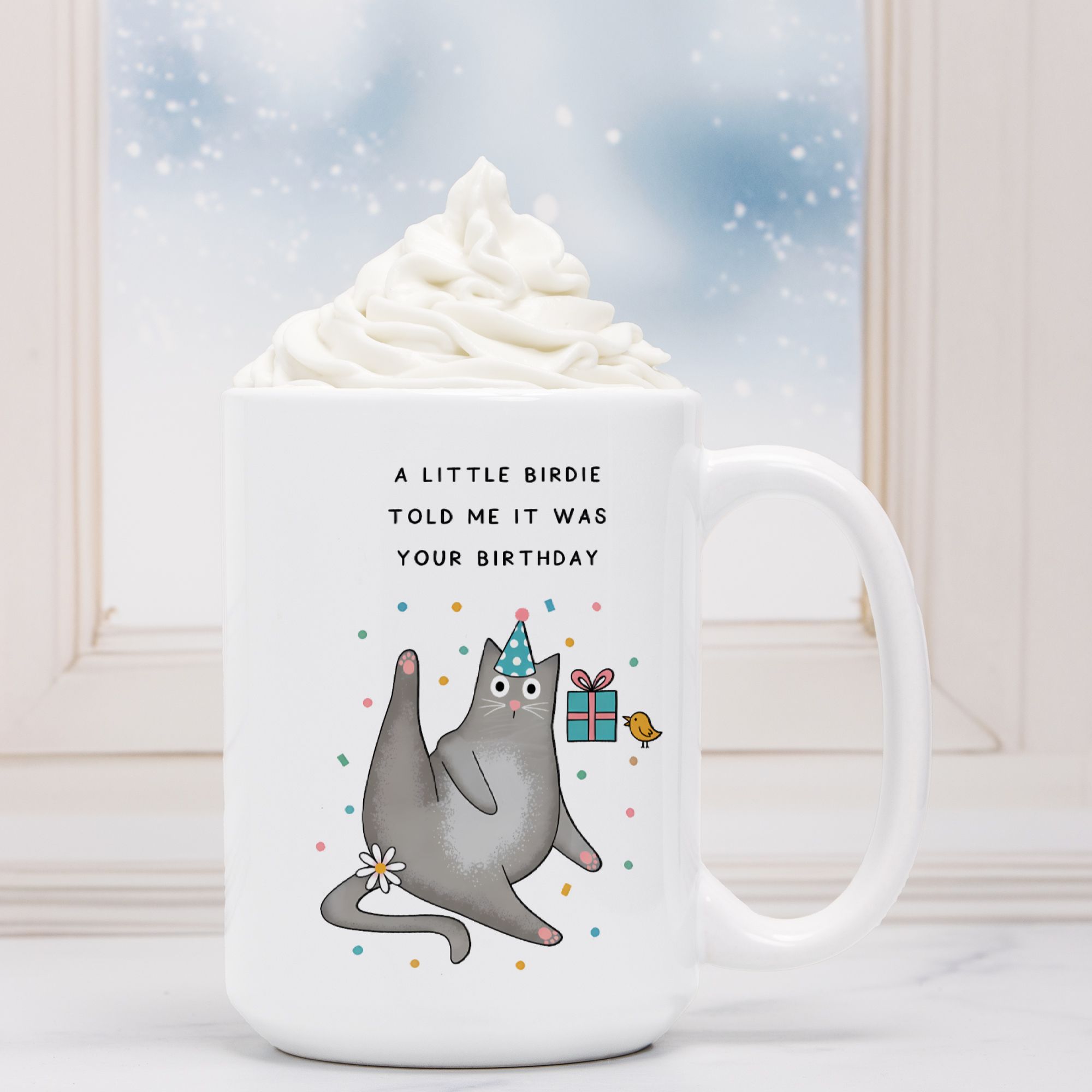White mug with a cartoon cat and birthday text on a white background