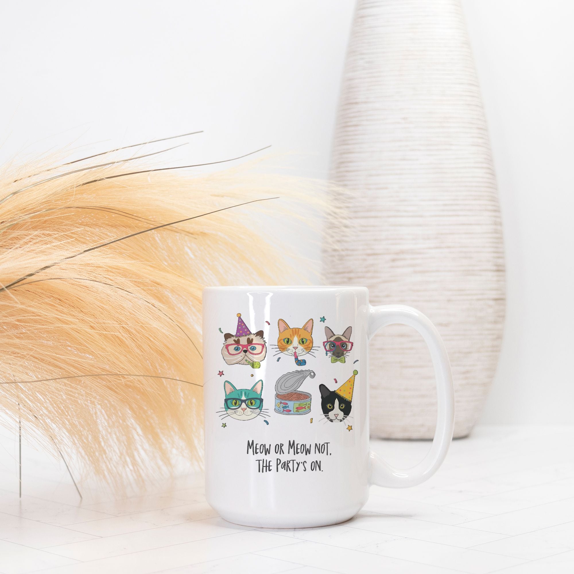 White mug with cat-themed designs and text on a white background