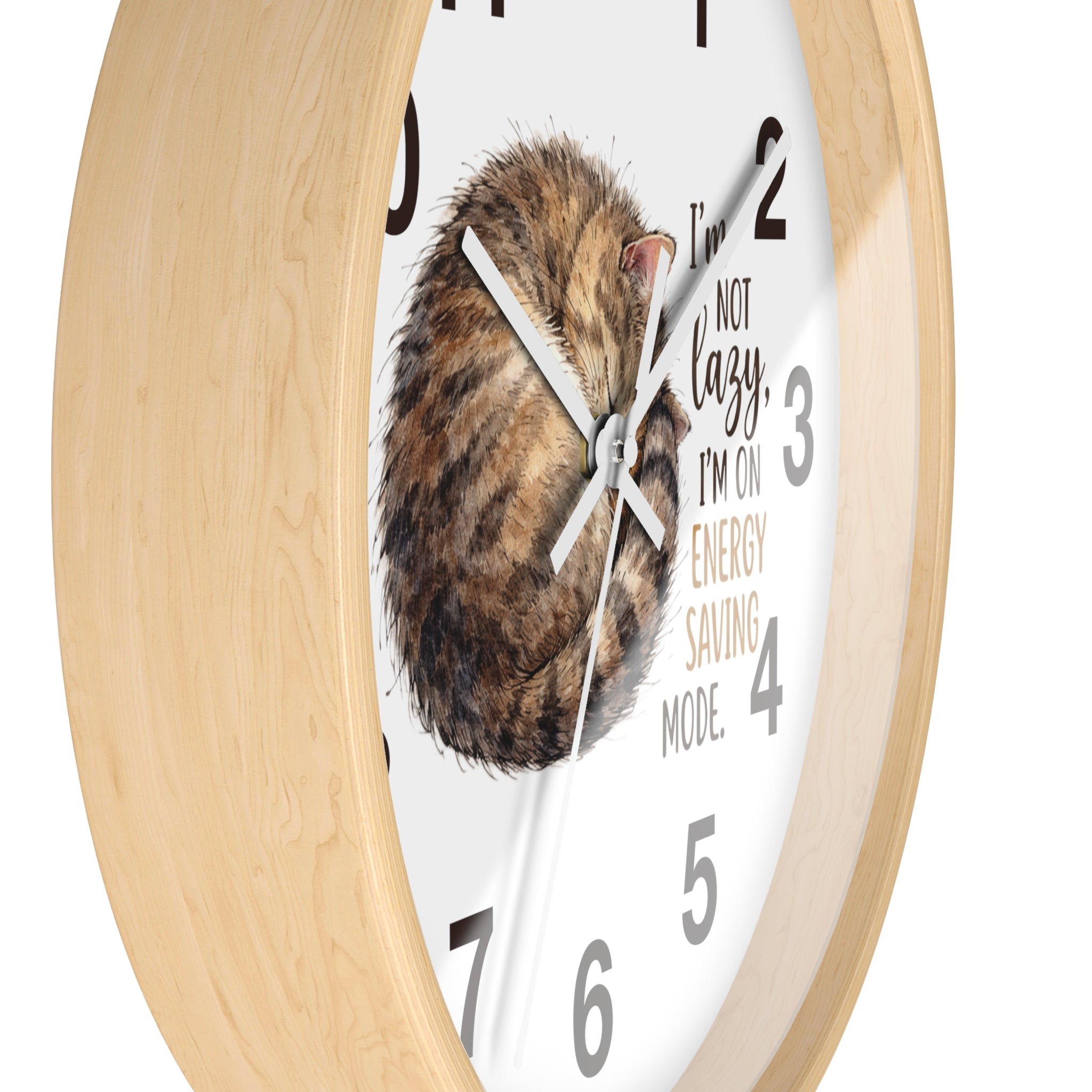 Side view of a round wood wall clock with a cat illustration and humorous text on a white background