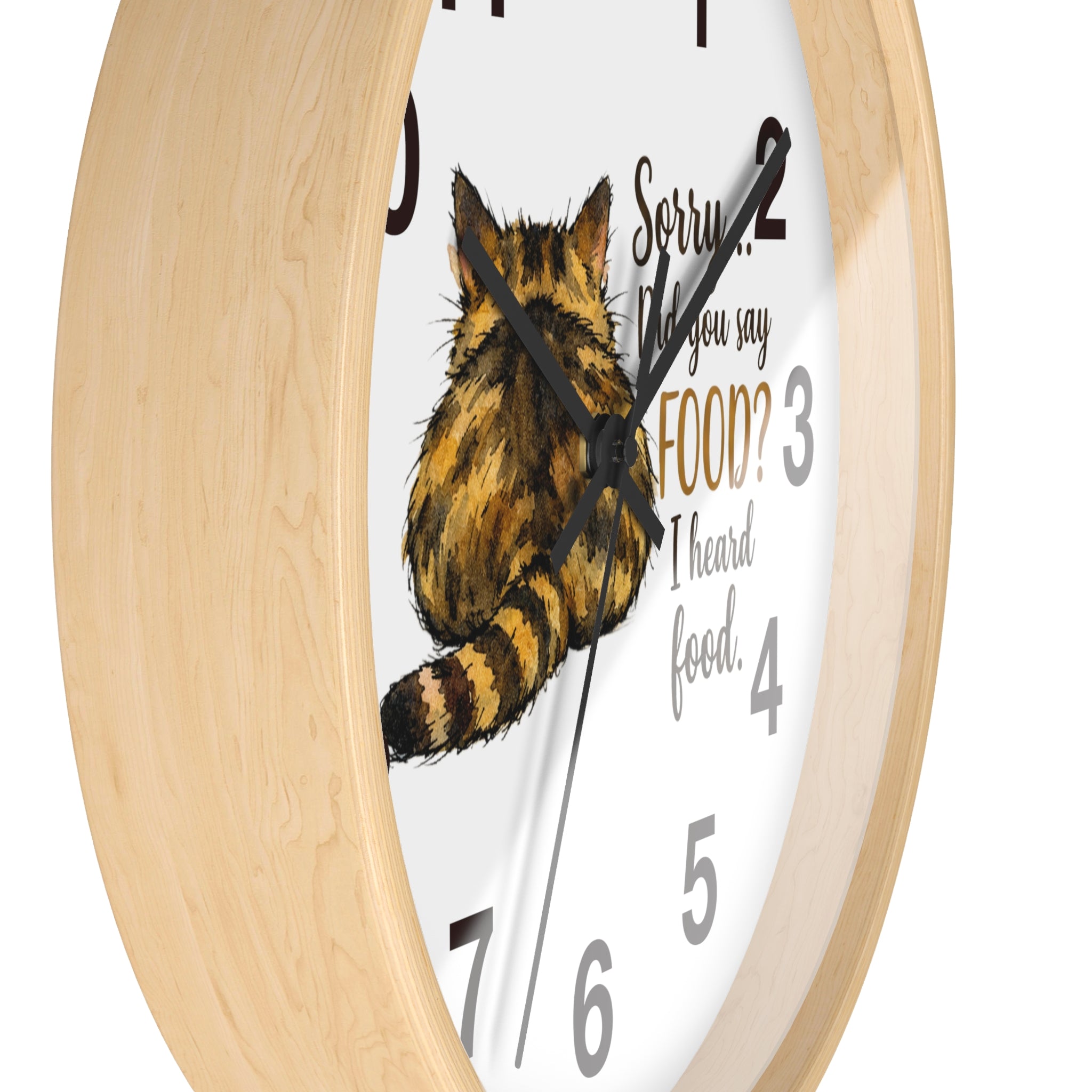 Side view of a round wood wall clock with a tabby cat illustration and humorous text on a white background