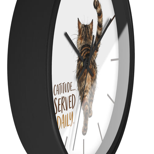 Side view of a round black wall clock with a cat design and 'Catitude Served Daily' text on a white background