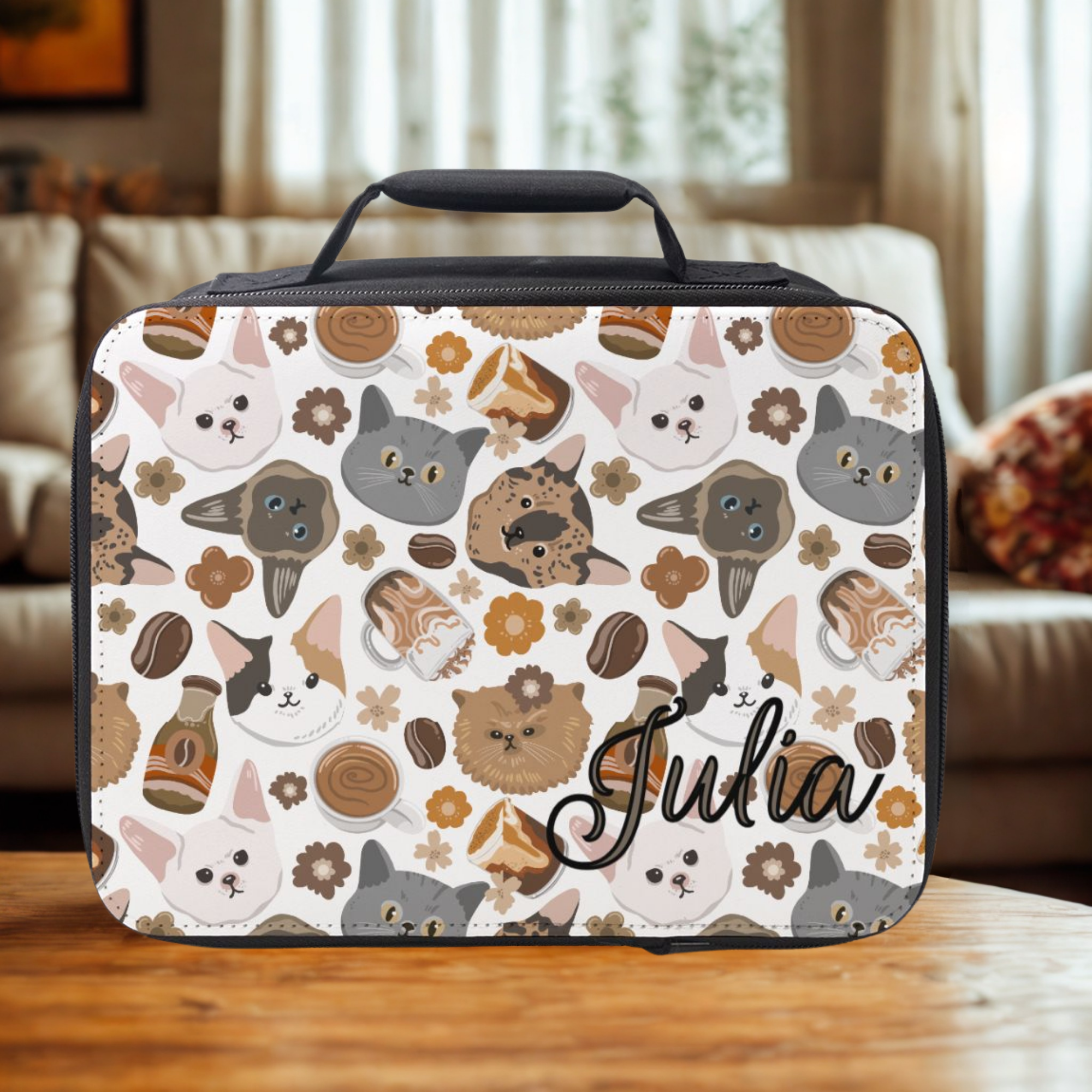  insulated lunch bag with cat pattern and 'Julia' text on a wooden coffee table in living room