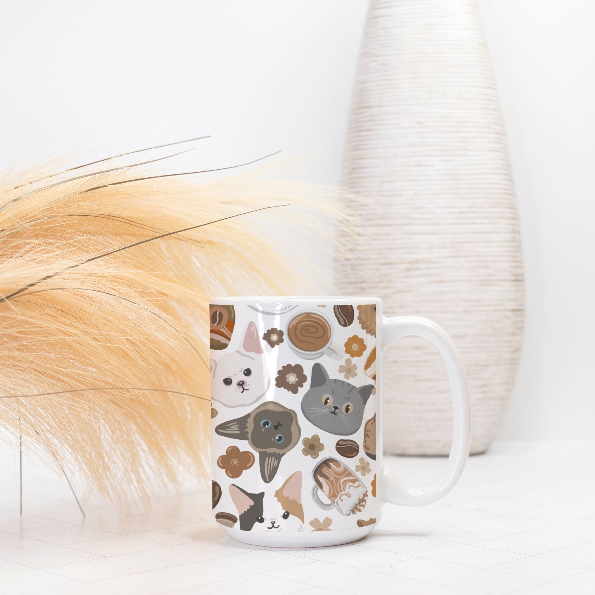 White mug with cat pattern on a white surface with decorative elements