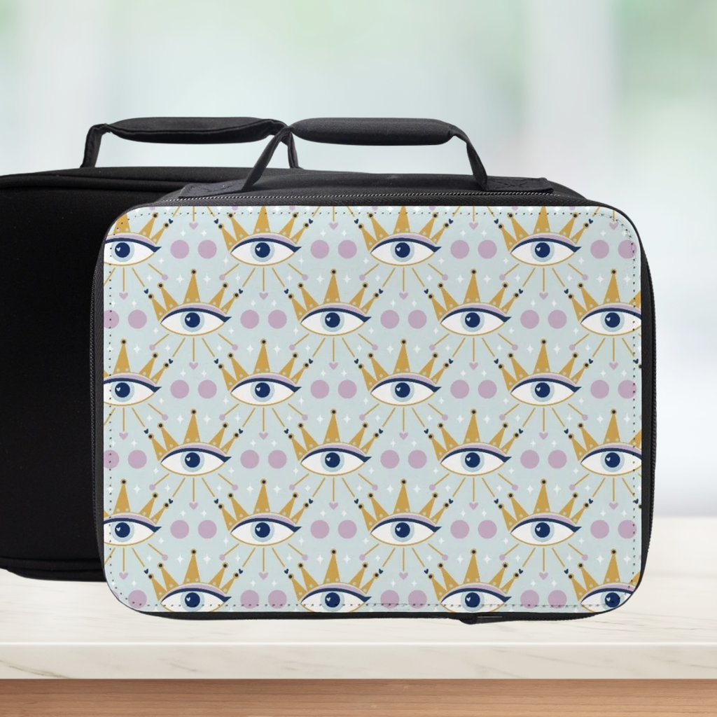 Insulated lunch bag with a celestial eye & crown pattern on a light blue background