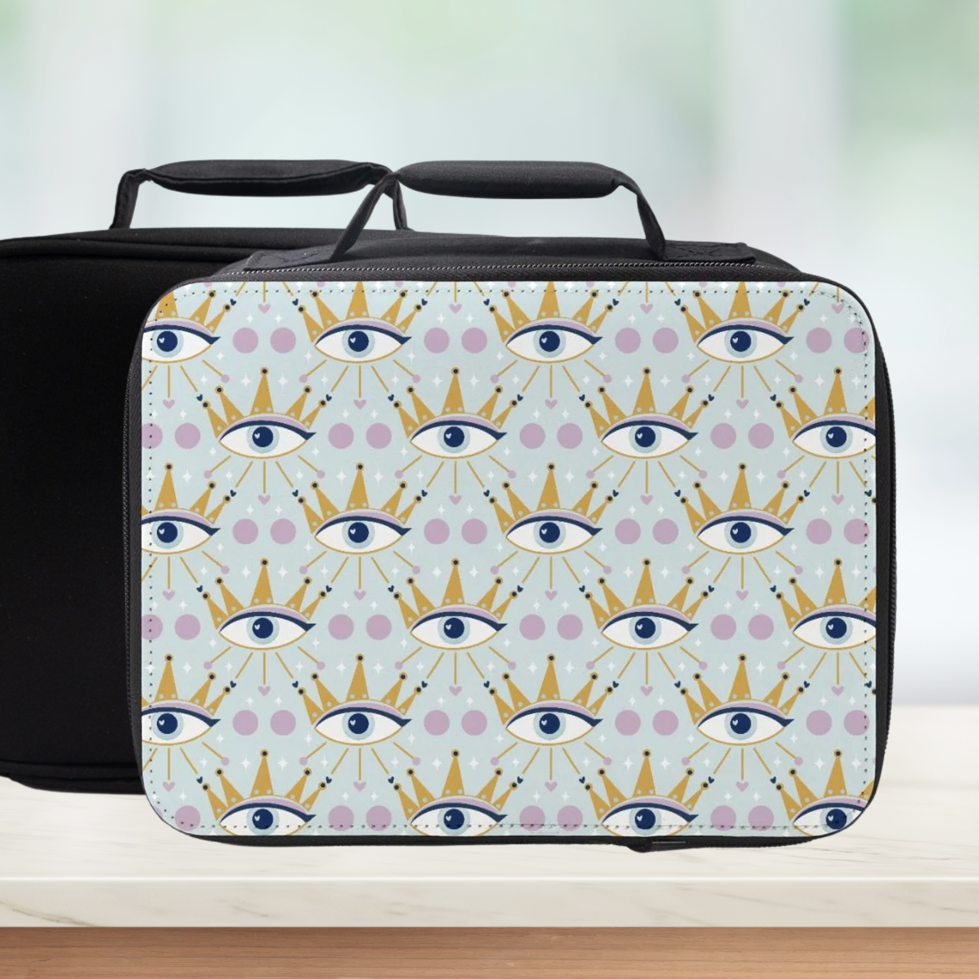 Insulated lunch bag with a celestial eye & crown pattern on a light blue background