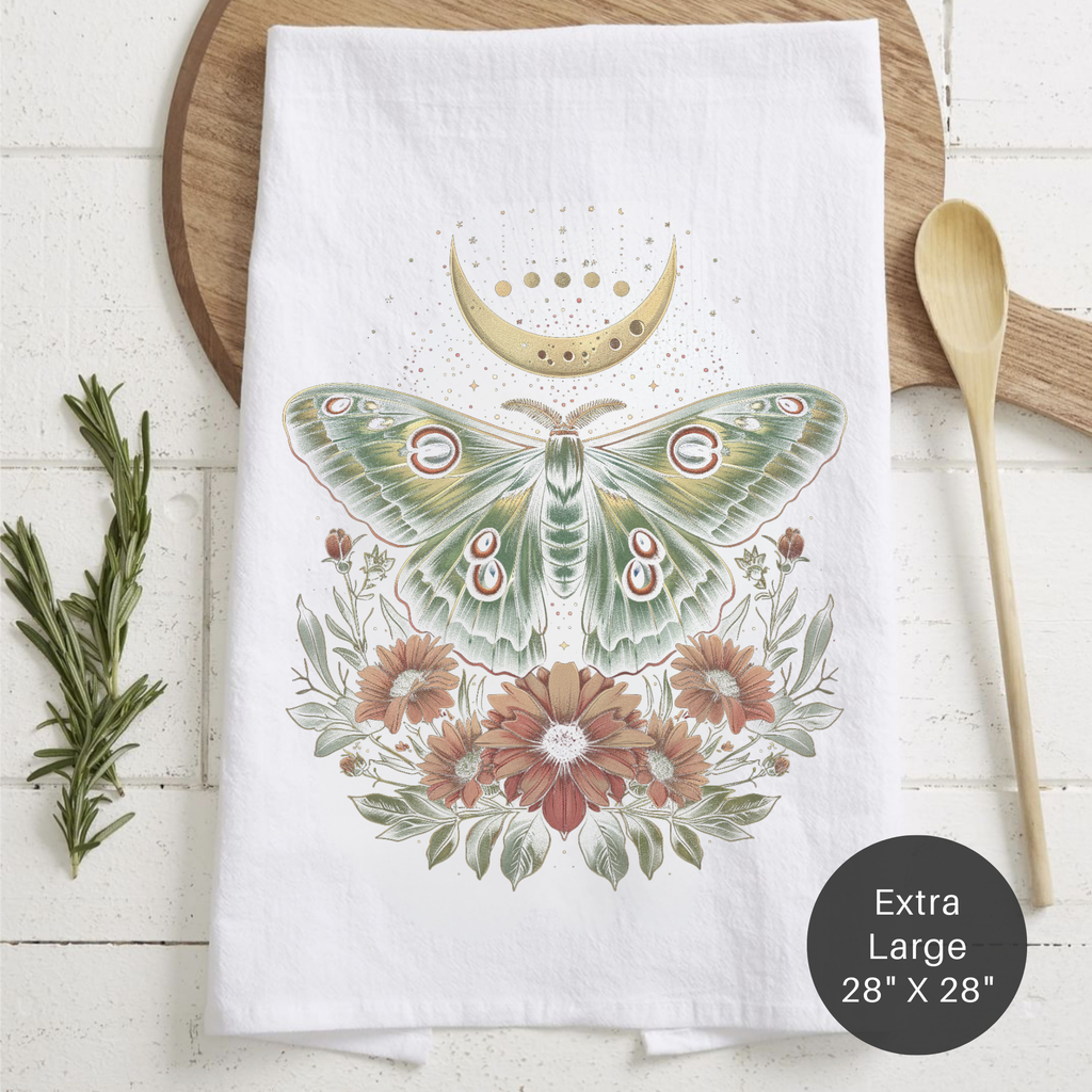Tea towel with moth and floral design on a wooden surface