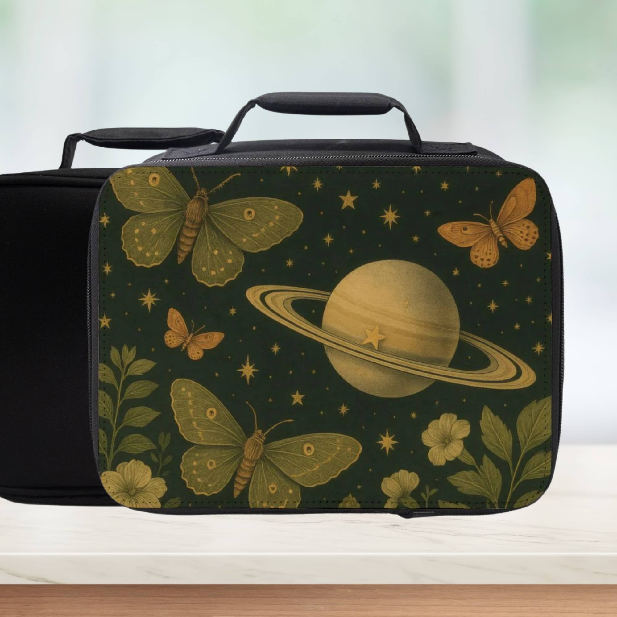 Black lunch bag with space-themed design featuring moths, flowers, and Saturn.