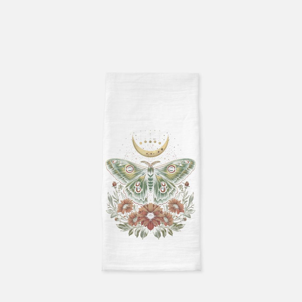 Decorative kitchen towel with a moth and floral design on a white background