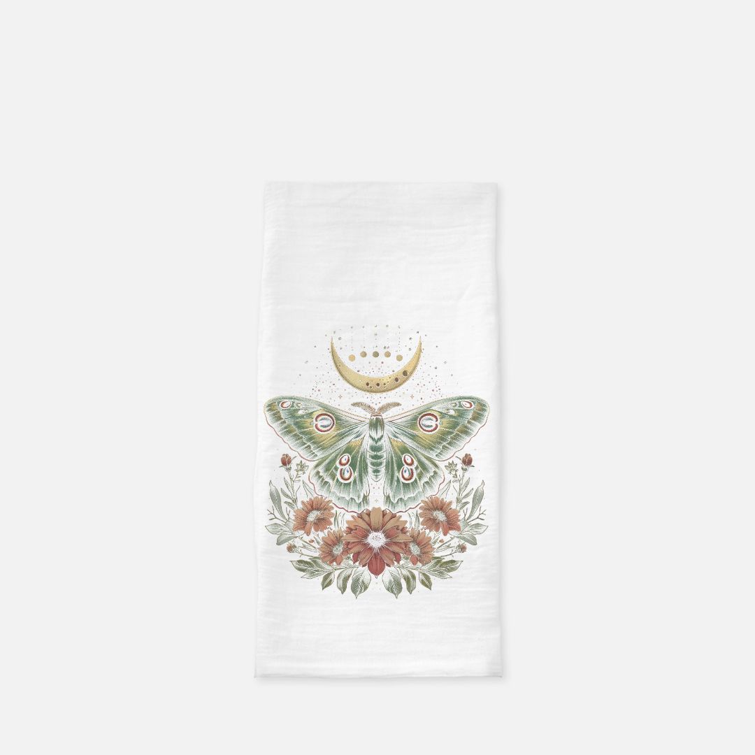 Decorative kitchen towel with a moth and floral design on a white background