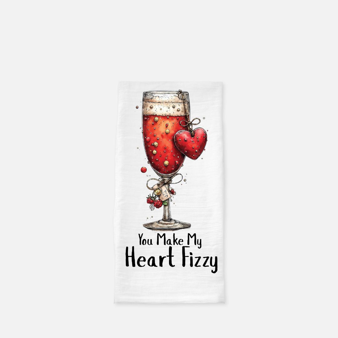 Tea towel with a glass of red drink and heart design, text 'You Make My Heart Fizzy' on a white background
