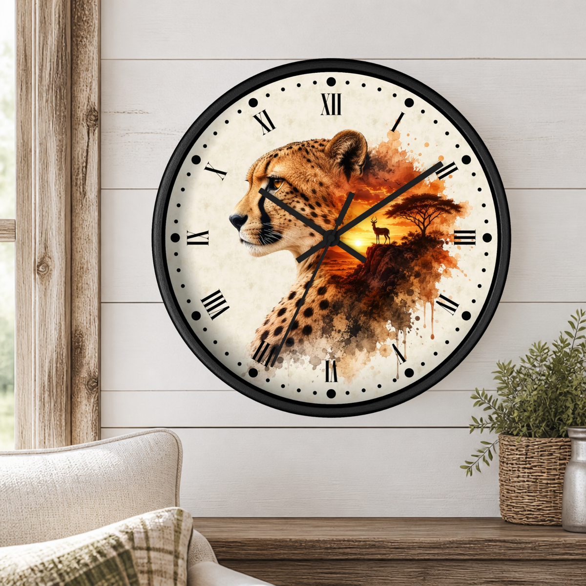A round wall clock with a black frame and a printed cheetah and savanna scene on the face, mounted on a white wood-paneled wall above a wooden table with a plant and part of a sofa visible.