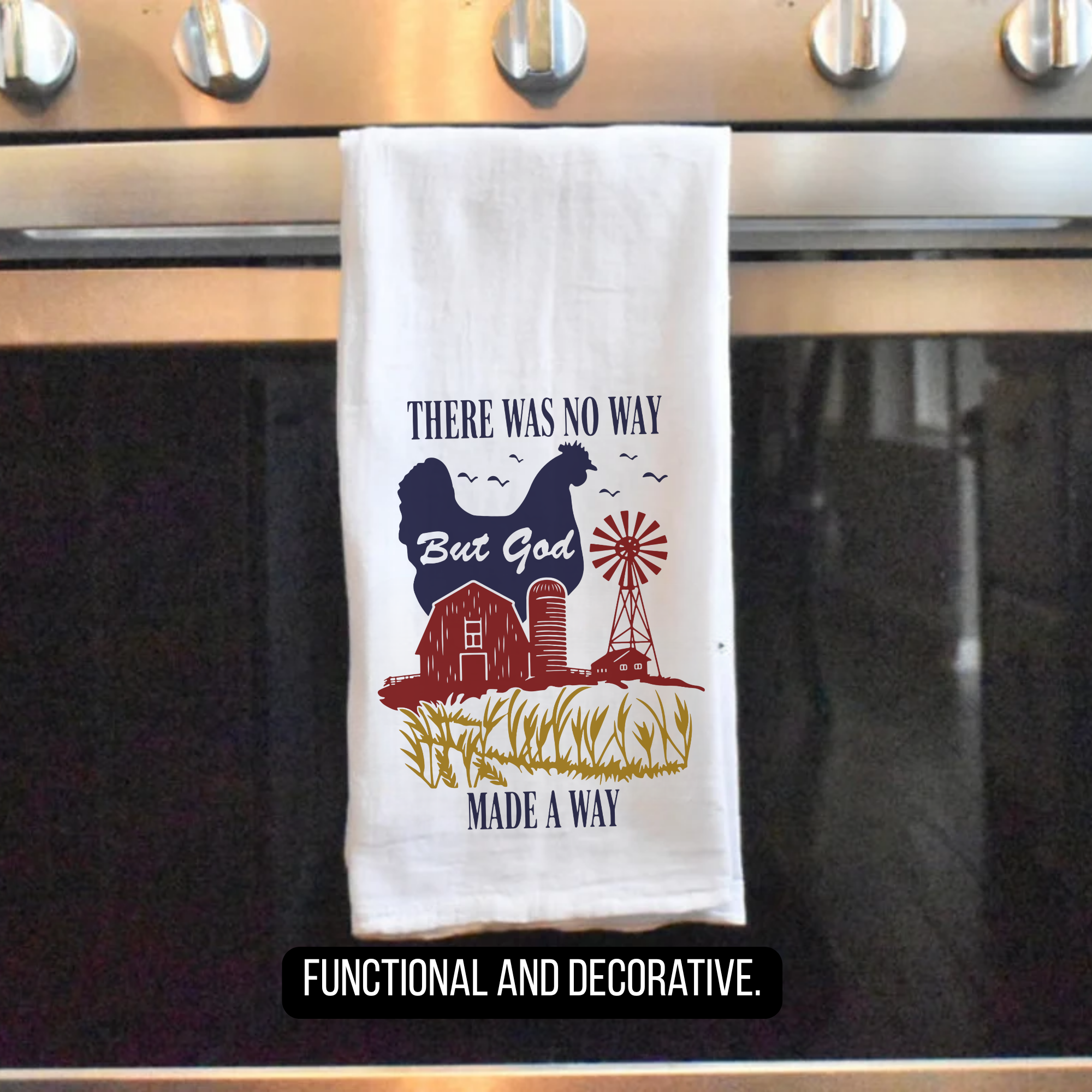 Decorative tea towel with farm-themed design hanging on a stove handle.
