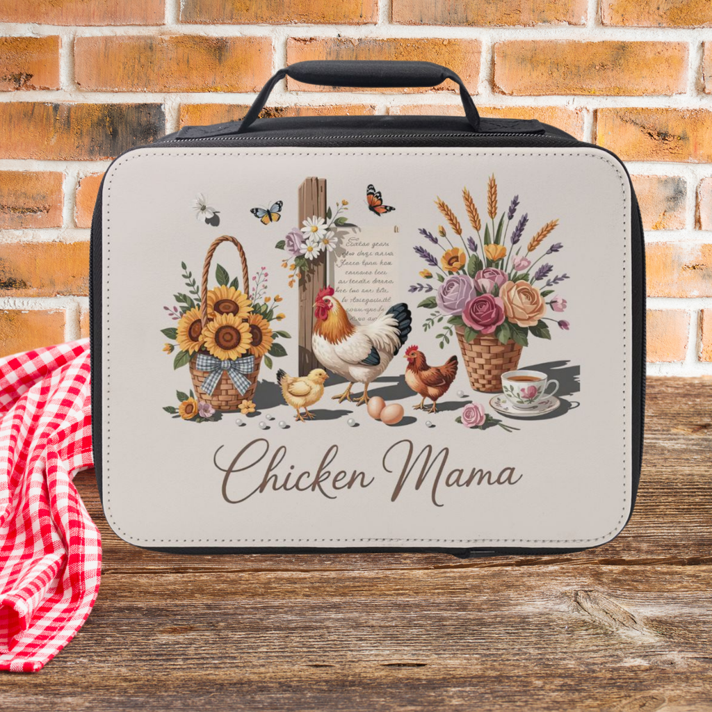 Lunch bag with 'Chicken Mama' design featuring chickens, flowers, and a cross on a wooden picnic table and brick background.