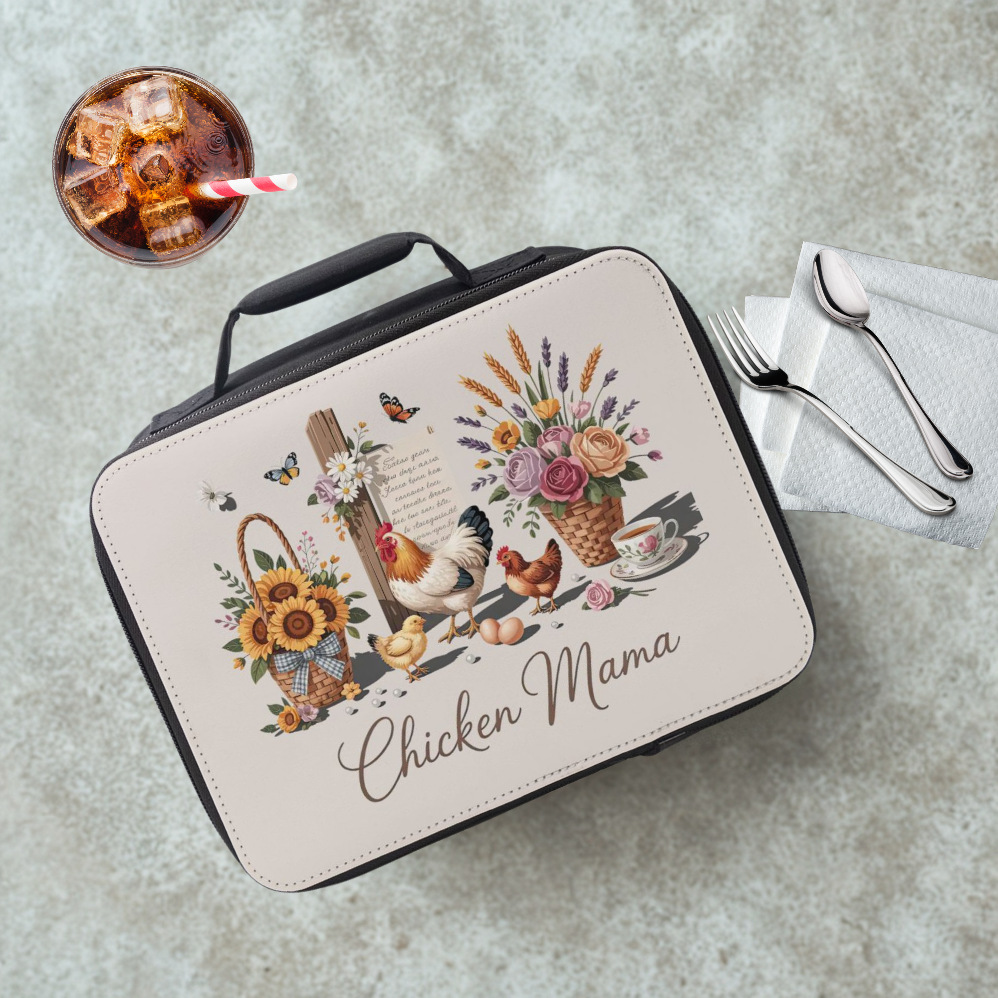  insulated lunch bag with 'Chicken Mama' design on a table with a drink and utensils.