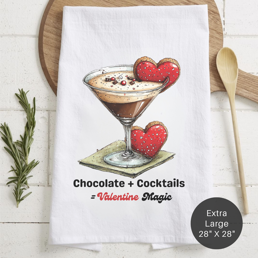 Tea towel with a chocolate cocktail and heart-shaped cookies design, text 'Chocolate + Cocktails = Valentine Magic', on a wooden board.
