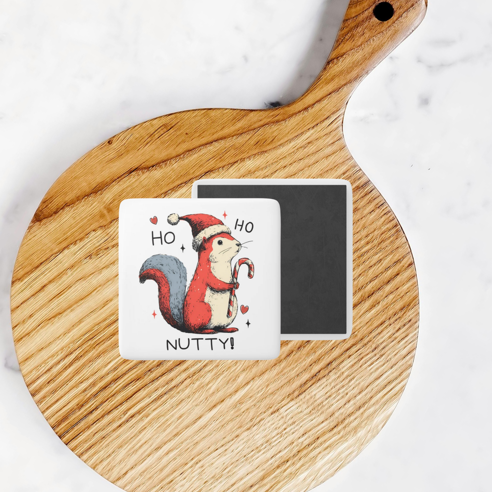 Fridge magnet with a Christmas-themed squirrel design on a wooden board.