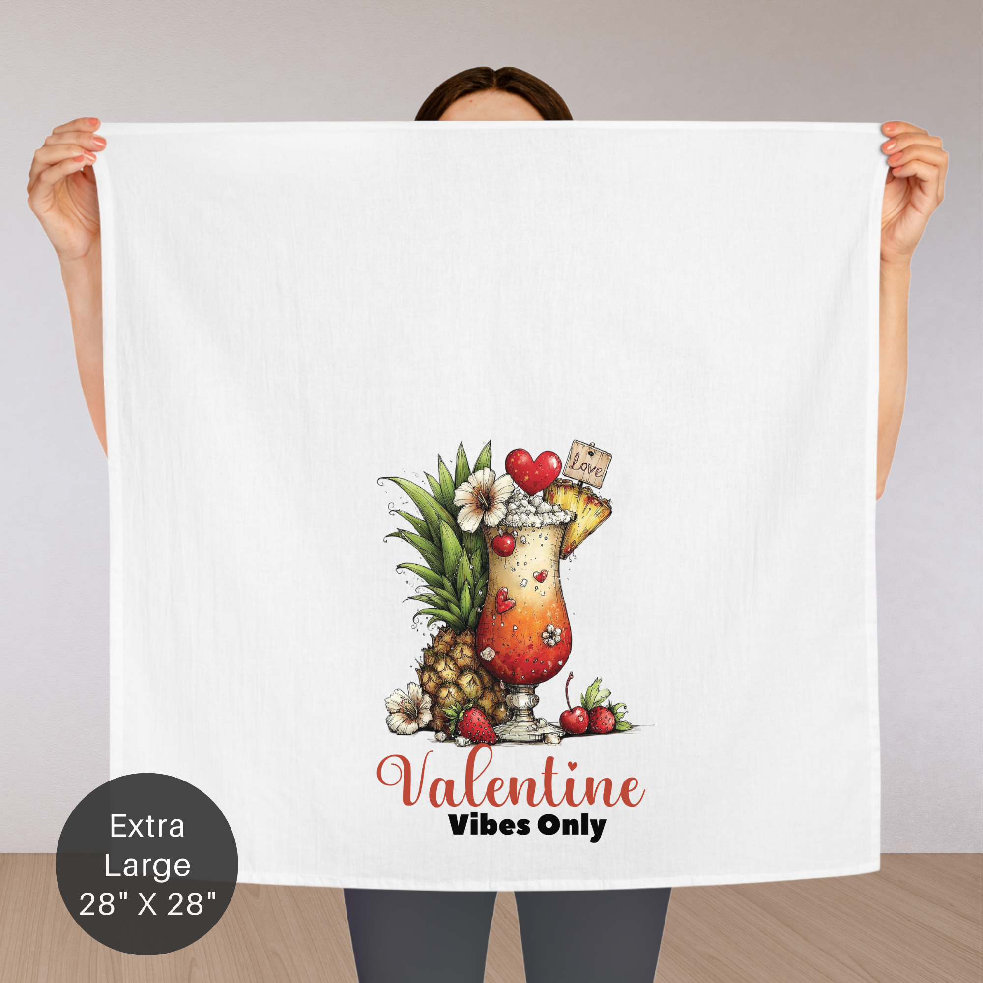 Person holding an extra large tea towel with a tropical drink design and 'Valentine Vibes Only' text.