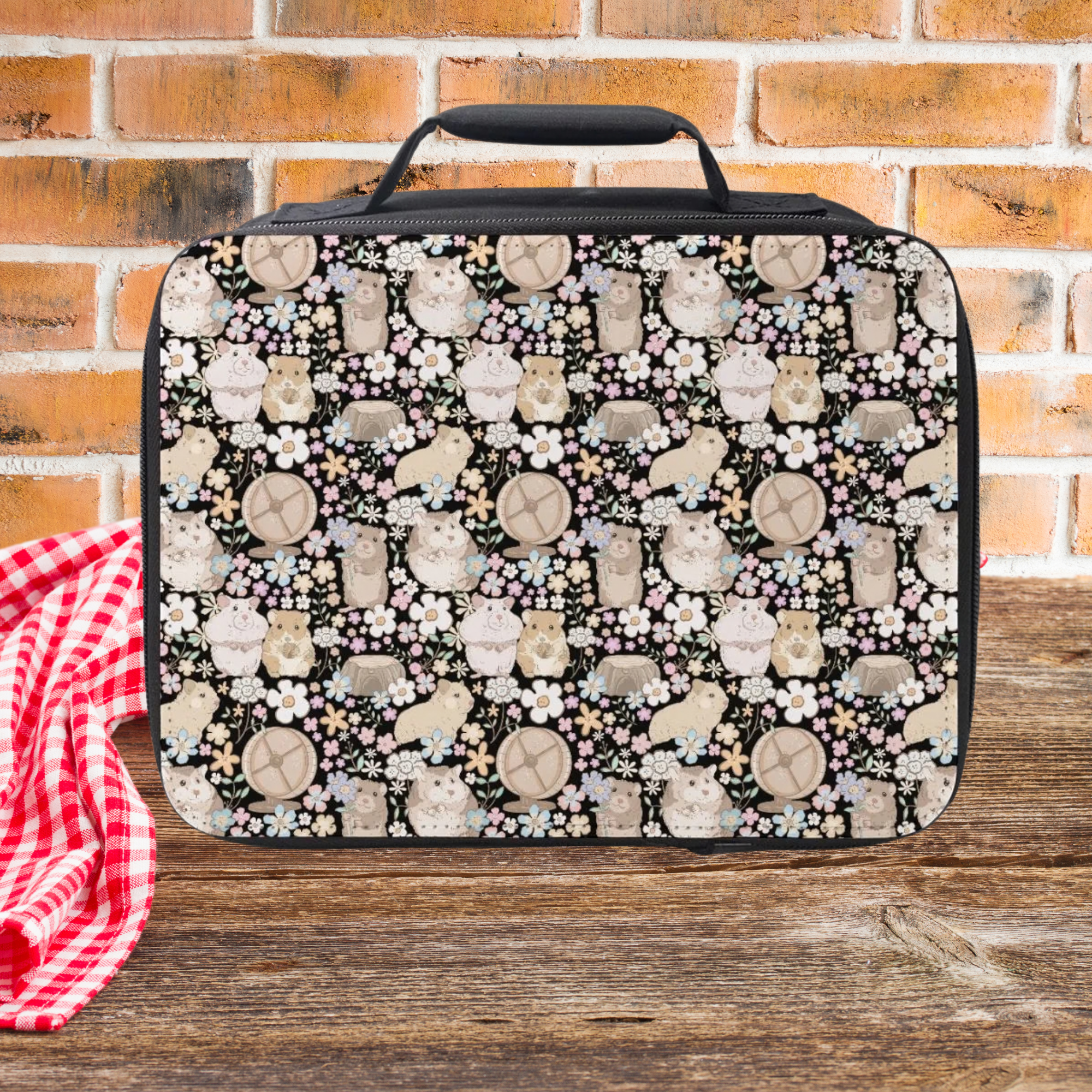 Lunch bag with hamster and flower pattern on a wooden picnic table with a brick wall background