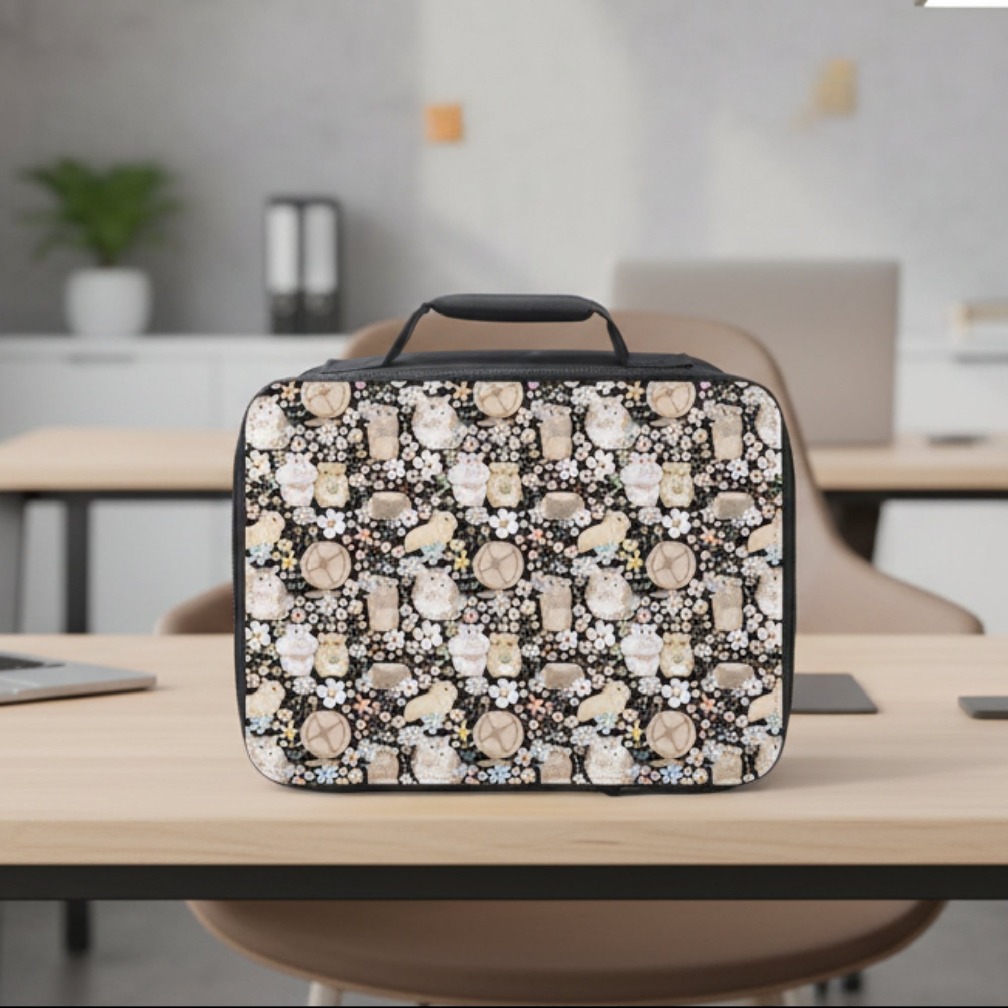 Lunch bag with hamster and floral pattern on a desk and blurred office background.