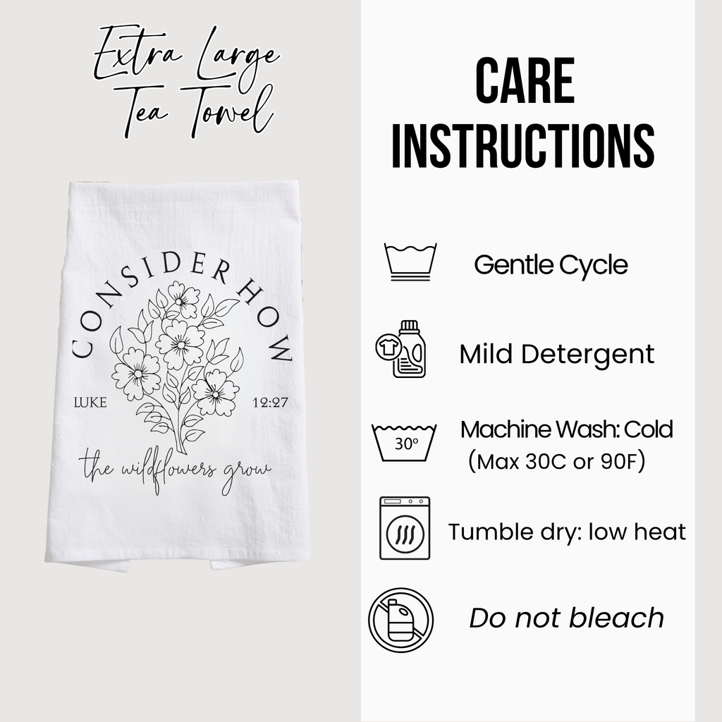 White tea towel with floral design and care instructions on a white background
