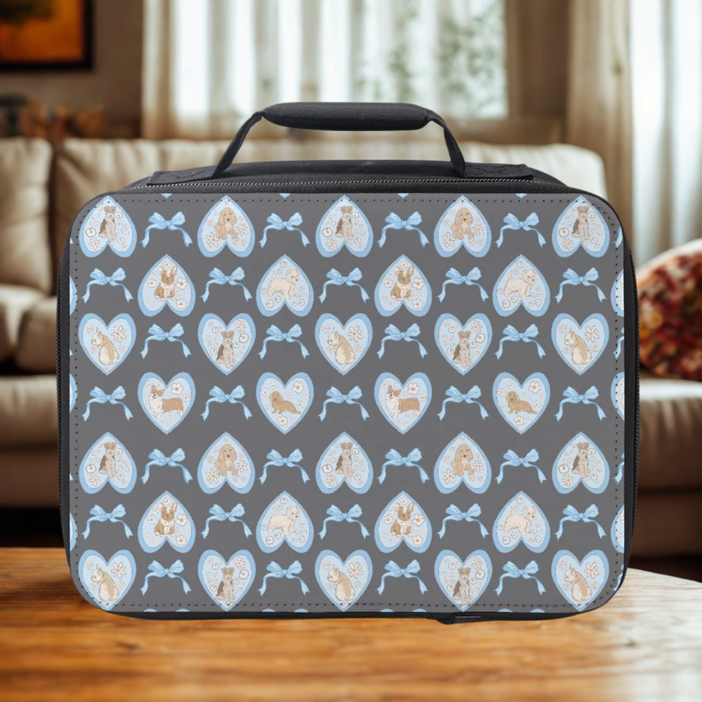 Rectangular lunch bag with hand drawn hearts, dogs, and bows pattern on a wooden coffee table in a cozy living room.