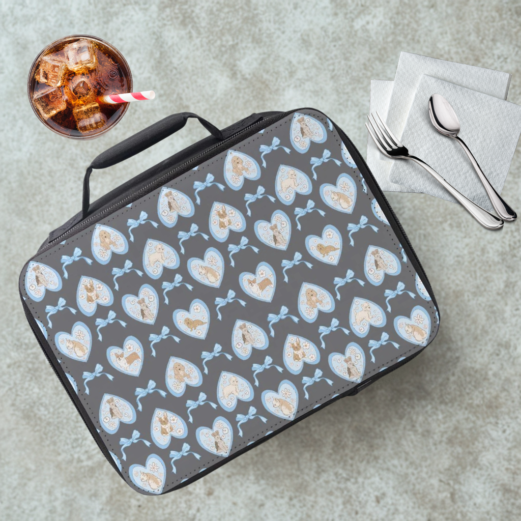 Gray lunch bag with hand drawn heart and dog pattern on a cafeteria table with a drink and utensils.