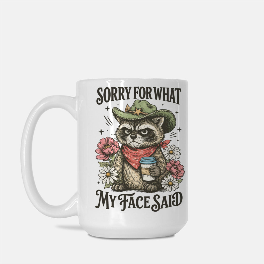 Mug with a raccoon illustration and text 'Sorry For What My Face Said' on a white background