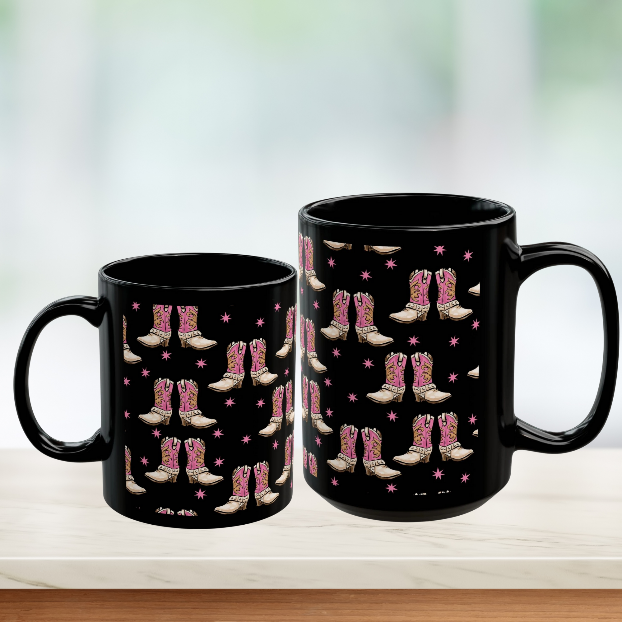 Two black mugs with pink cowboy boot pattern on a light background