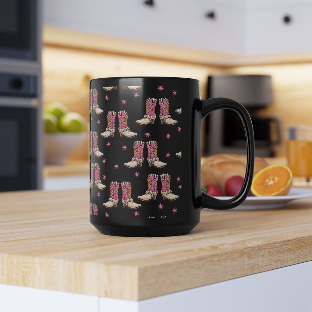 15 oz. Black mug with pink cowboy boot pattern on a kitchen counter
