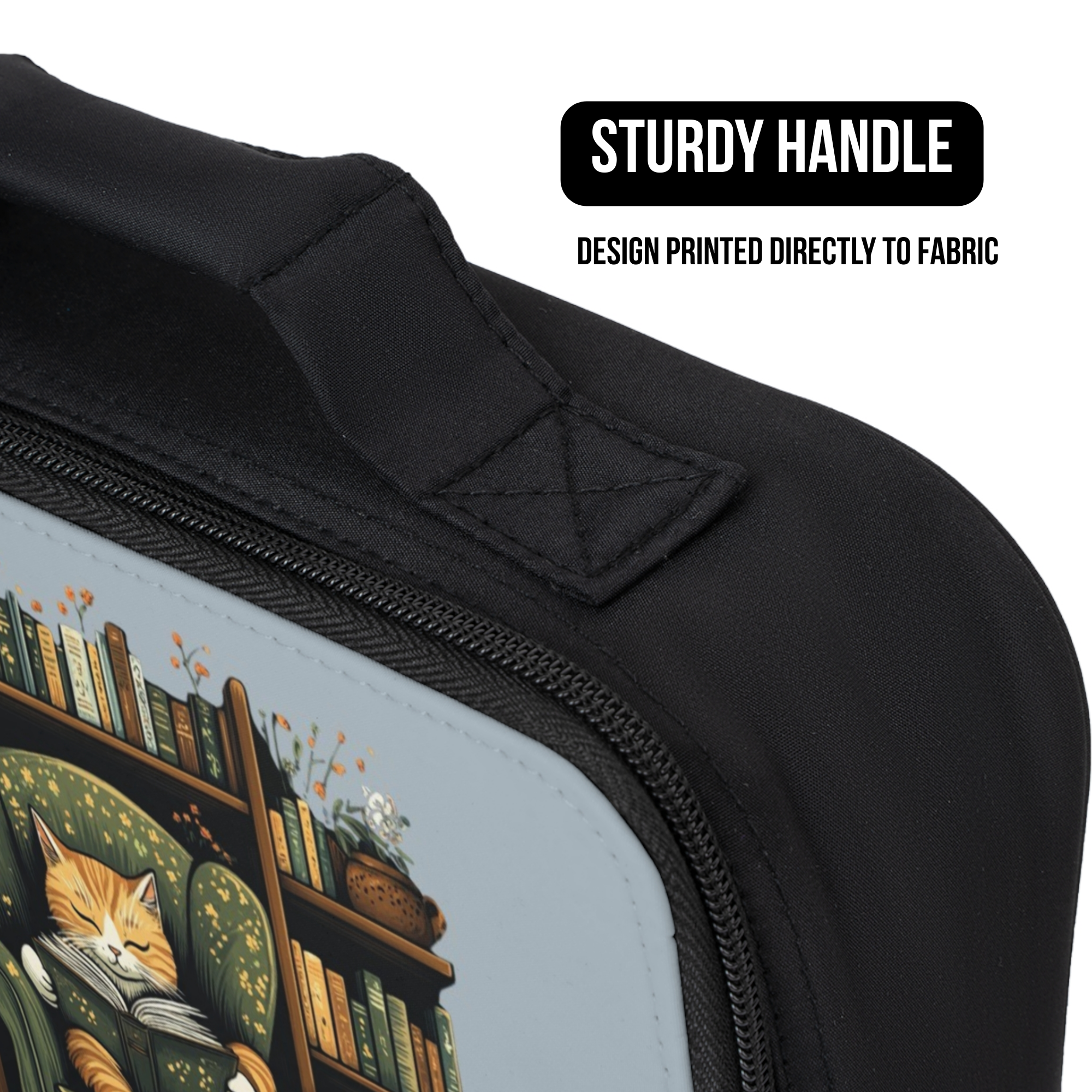 Black bag with a design of a cat and books and a sturdy handle, text indicating design printed directly to fabric.