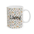 Mug with a pattern of cats, flowers, and the name 'Laney' on a white background