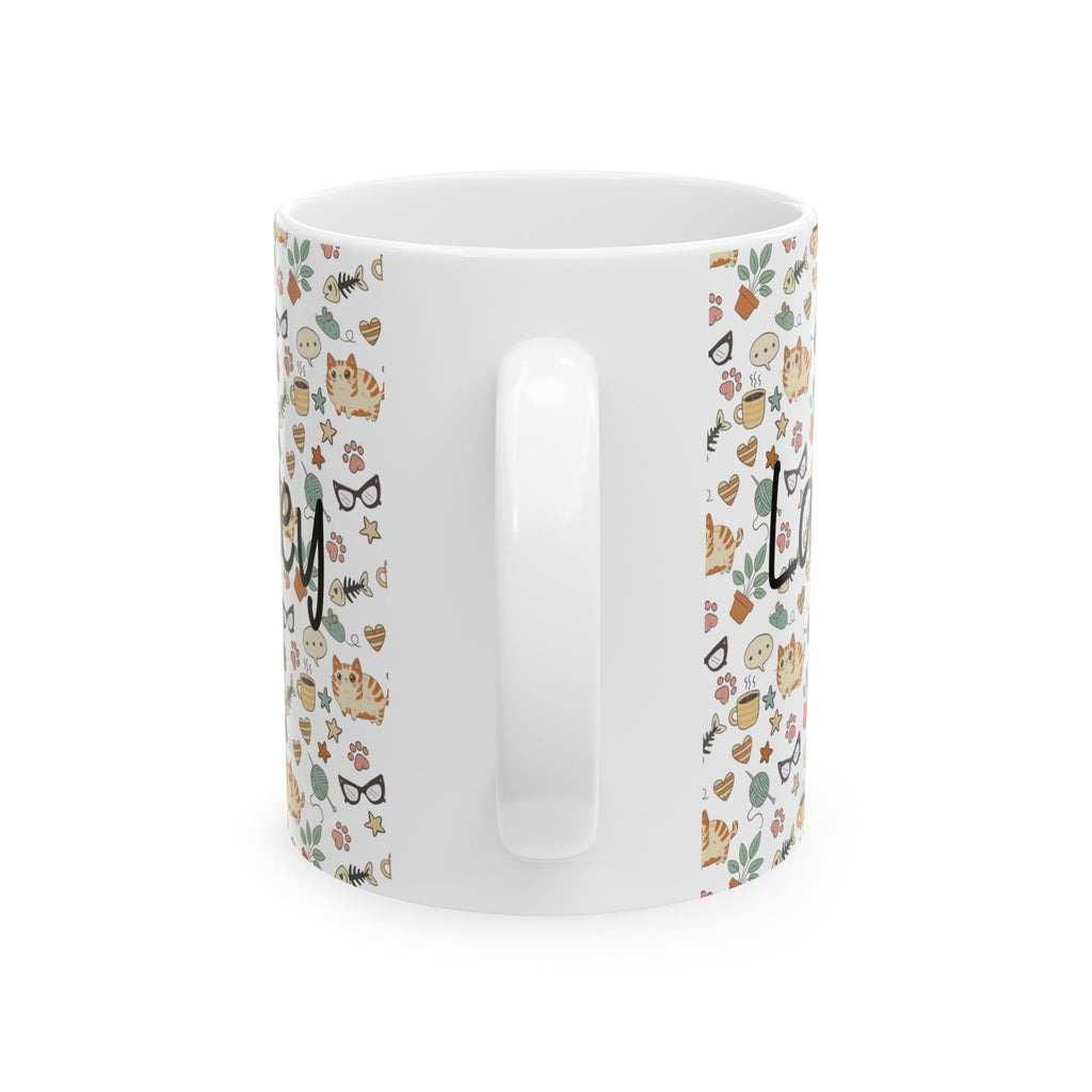 Back side of a white mug with cat-themed pattern on a white background