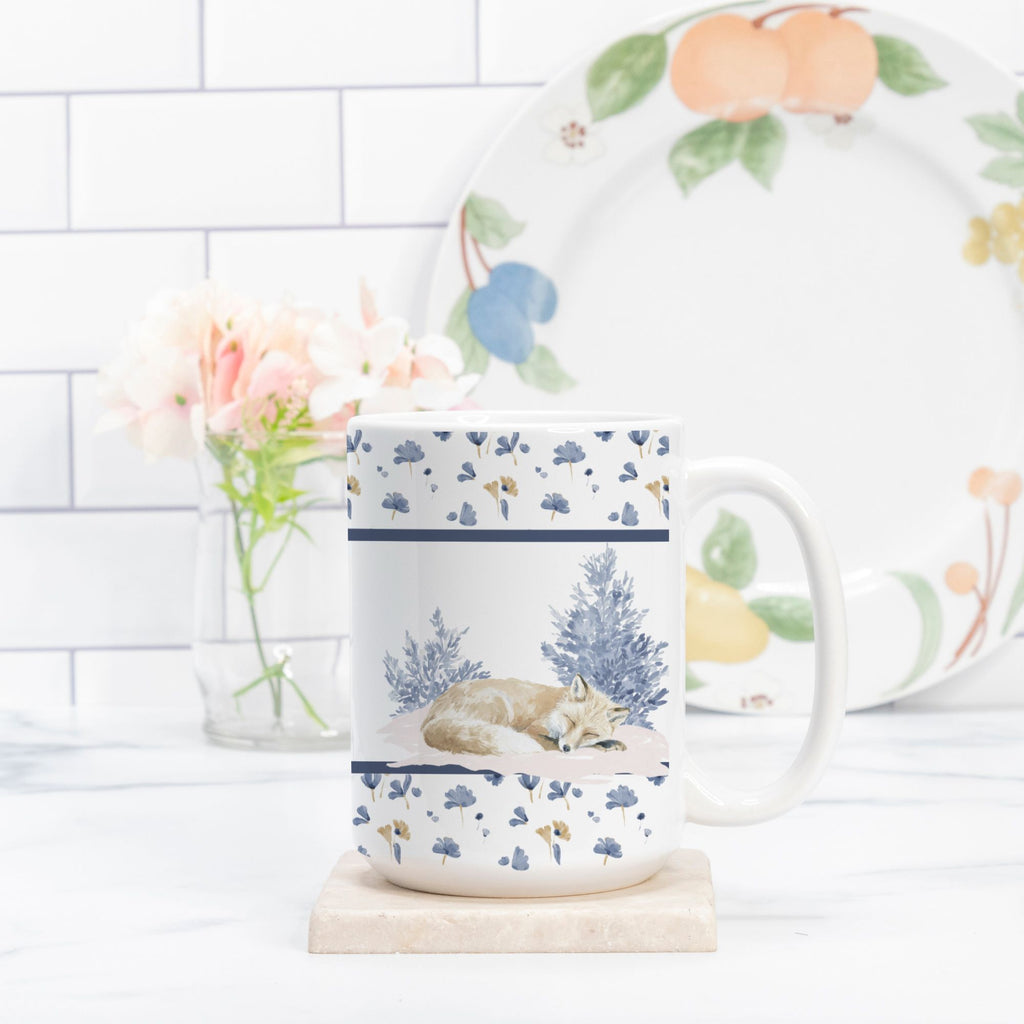 Mug with nature-themed design on a white surface with a blurred background