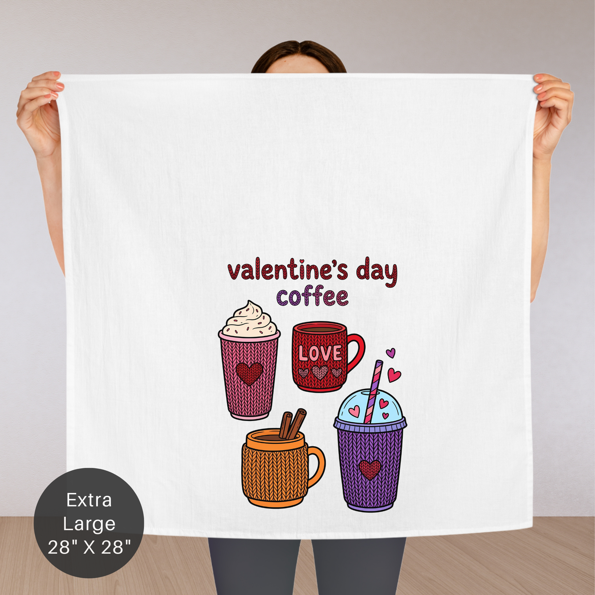 Person holding an extra large towel with Valentine's Day coffee-themed design.