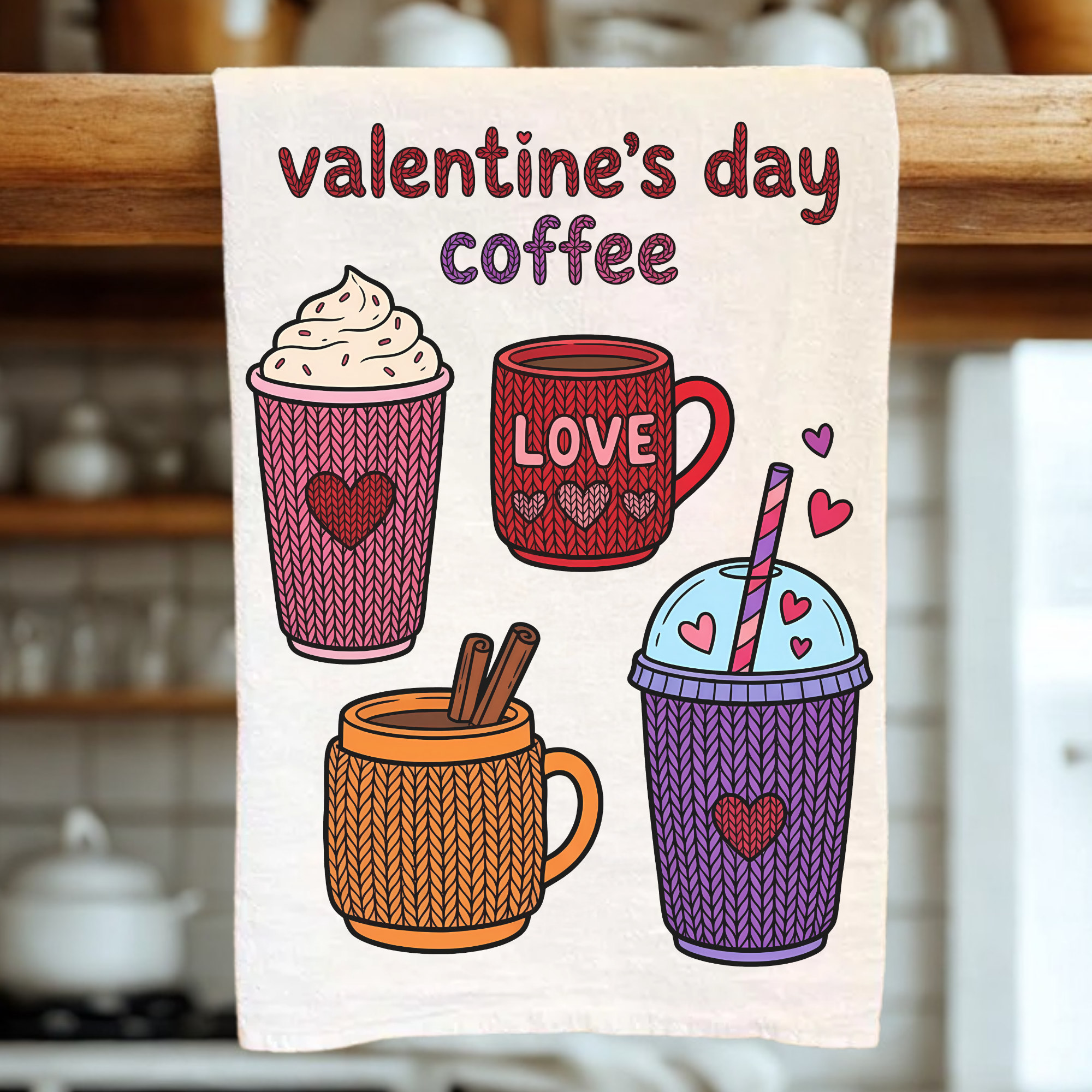 Valentine's Day-themed coffee-themed towel with illustrations of coffee cups and hearts on a wooden rack.