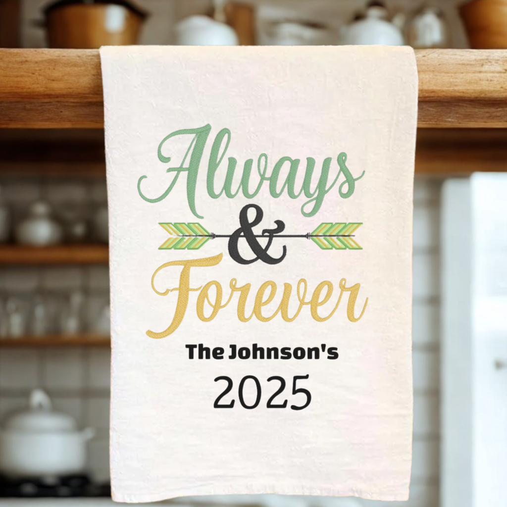 White tea towel with 'Always & Forever' Text with the personalized text 'The Johnson's 2025' hanging from a wooden rack.