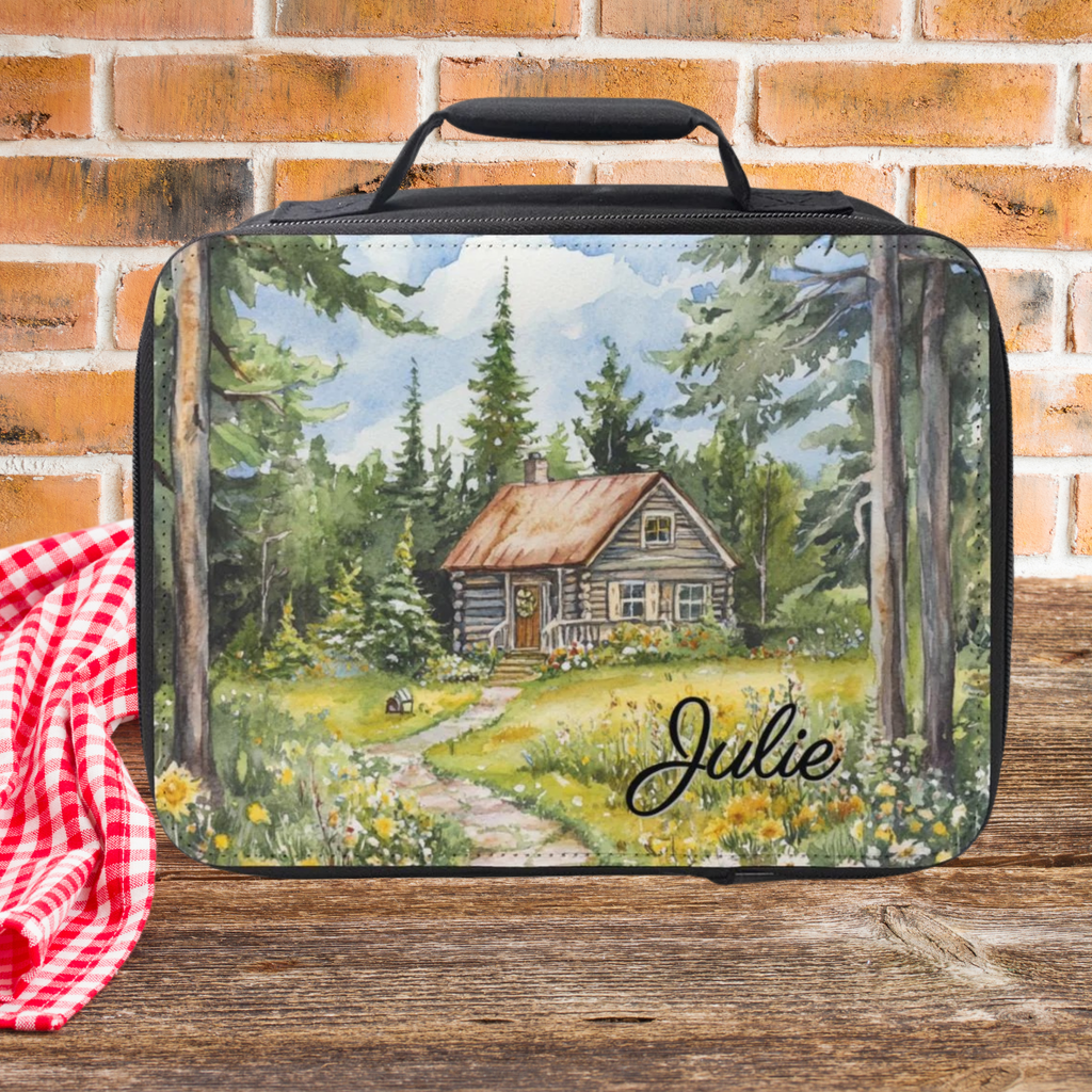 Lunch bag with a forest scene and cabin design, featuring the name 'Julie', on a brick wall background.